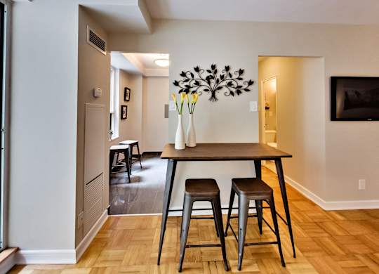 a dining room with a wooden table and three stools