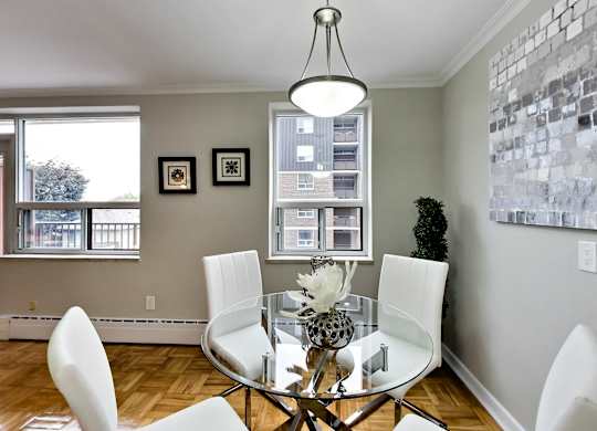 an image of a dining room with a glass table and chairs