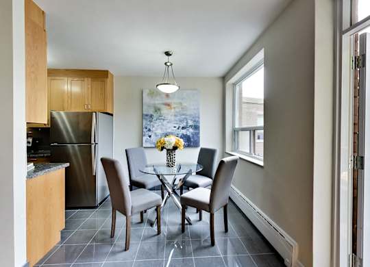 a dining room with a table and chairs and a kitchen