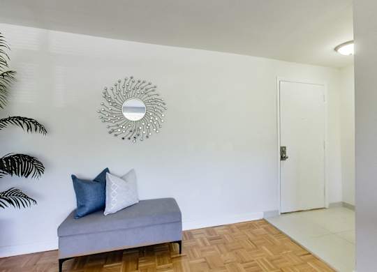 a living room with a couch and a mirror on the wall