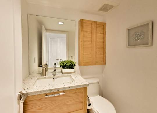 a bathroom with a sink toilet and a mirror