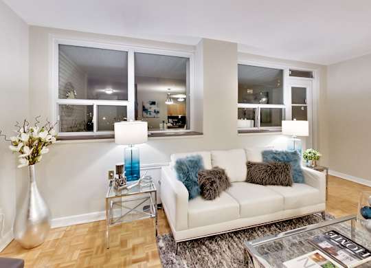 a living room with a couch and a glass table