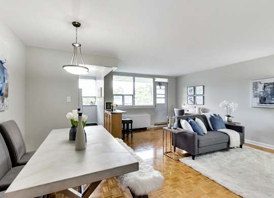 a living room with a dining room table and a couch