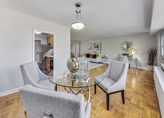 a living room with chairs and a glass table