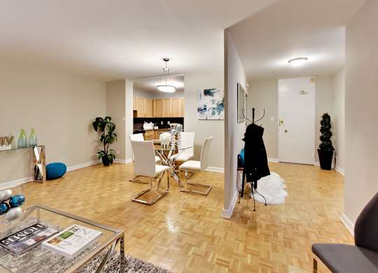 a living room and dining room area with a table and chairs