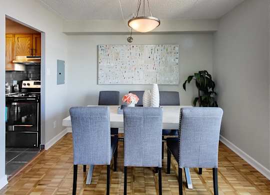 an image of a dining room with a table and chairs