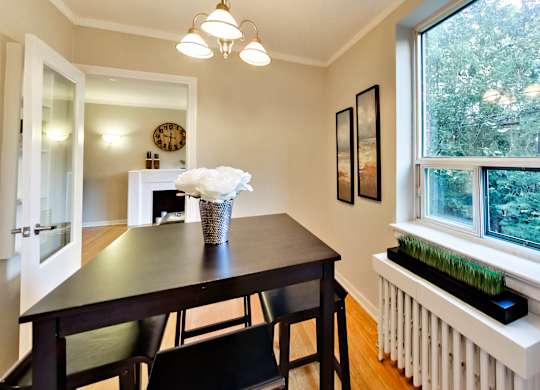 a dining room with a table and chairs and a large window