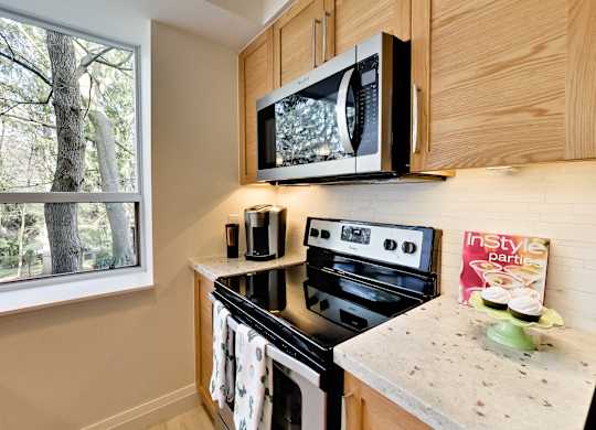 a kitchen with a stove microwave and a window