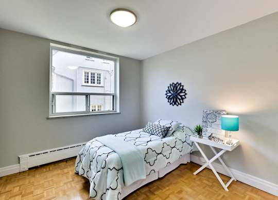 a bedroom with a bed and a window