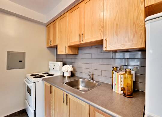 a kitchen with white appliances and wooden cabinets