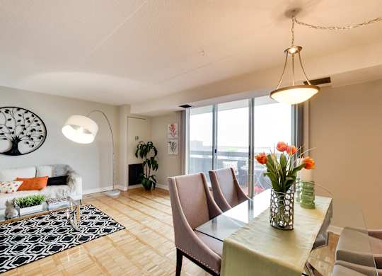 a living room and dining room with a table and chairs