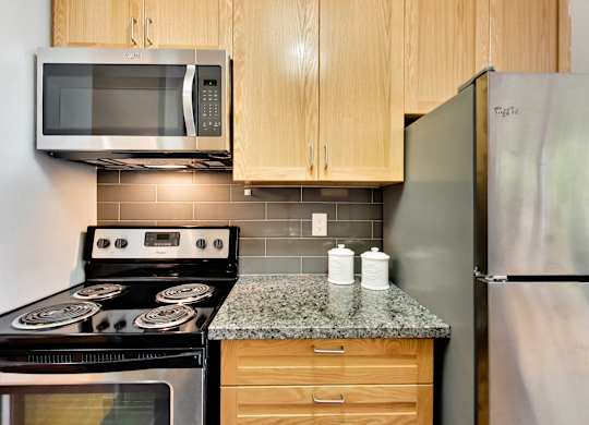 a kitchen with stainless steel appliances and a granite counter top