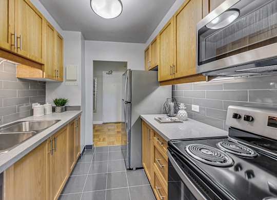 a kitchen with stainless steel appliances and wooden cabinets