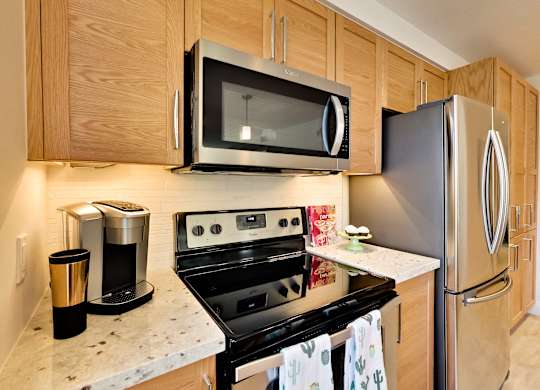 a kitchen with stainless steel appliances and wooden cabinets