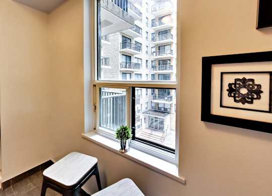 a small living room with a window and a table and stools