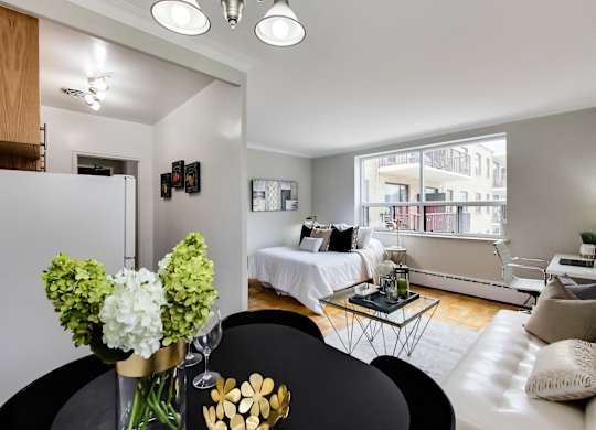a living room with a couch and a table and a bed
