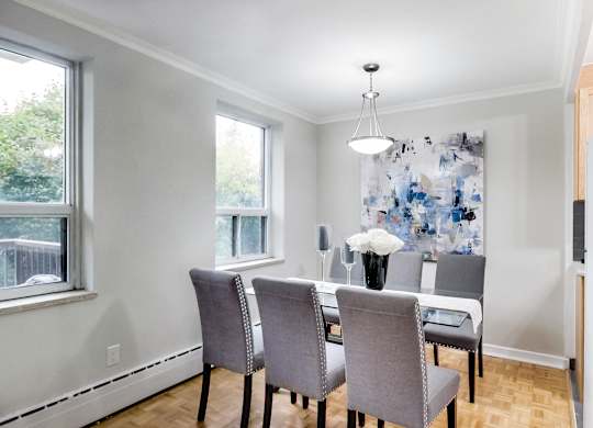 an image of a dining room with a table and chairs