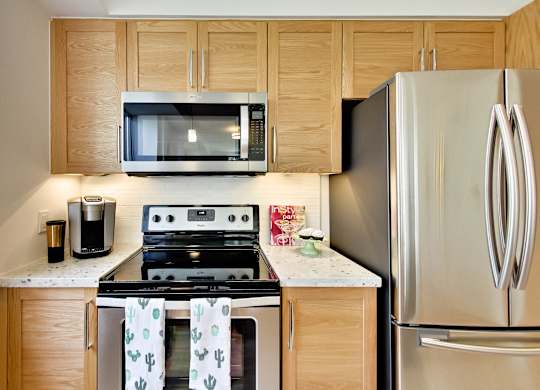 a kitchen with stainless steel appliances and wooden cabinets