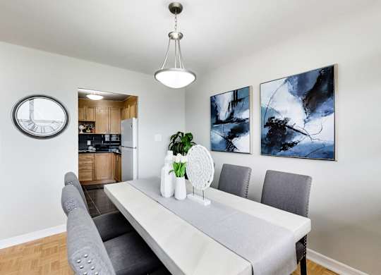 a dining room with a white table and chairs