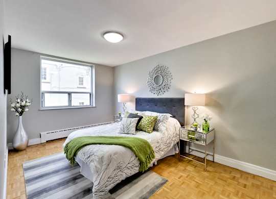 a bedroom with a bed and a mirror on the wall