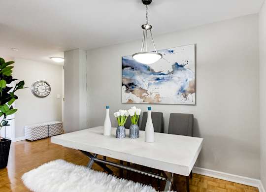 a dining room with a white table and a white rug