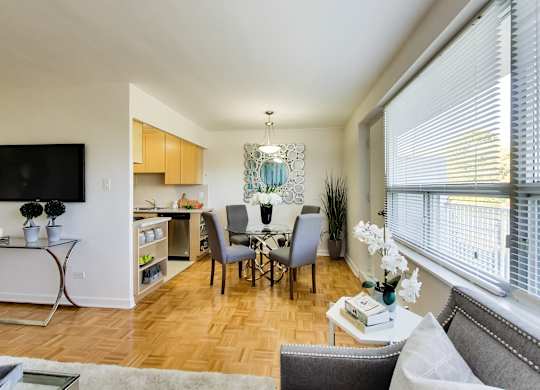 a living room and dining room with a table and chairs