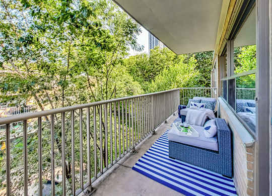 a balcony with a couch and a table on it