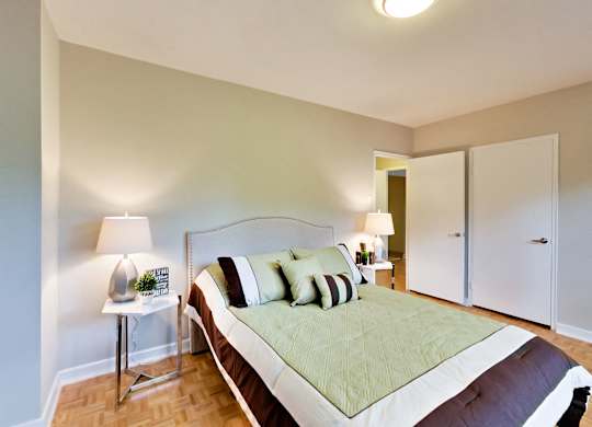 a bedroom with a large bed and a closet