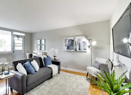 a living room with a couch and a chair and a tv