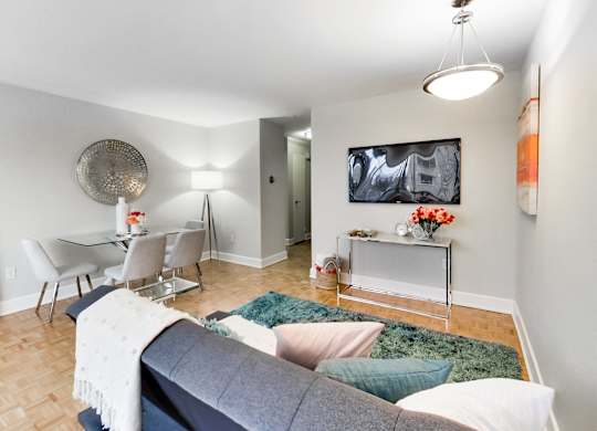 A living room with a grey couch and a white coffee table.