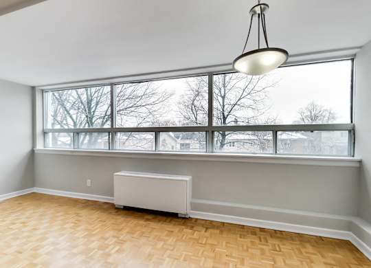 an empty living room with a large window