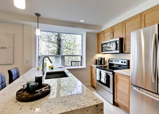 a kitchen with stainless steel appliances and granite counter tops