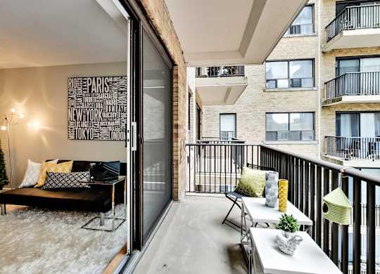 a living room with a couch and a table on a balcony