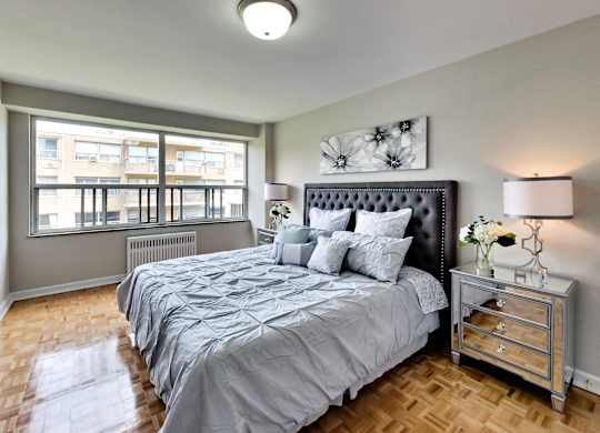 a bedroom with a large bed and a window