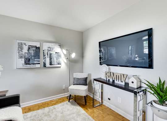 an apartment living room with a large tv and a couch