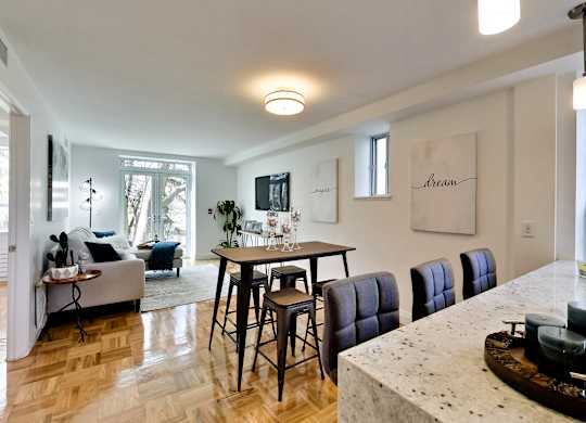 a living room and dining room with a table and chairs