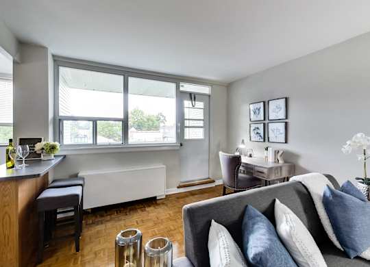 a living room and dining room with a couch and chairs and a table with chairs