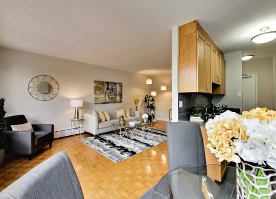 a living room with a glass dining room table and a couch