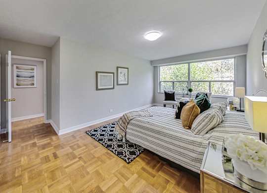 a bedroom with a large bed and a window