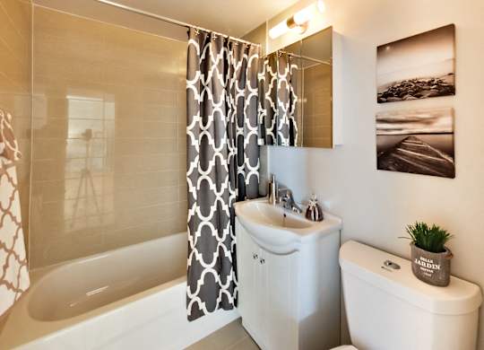 a bathroom with a shower curtain and a toilet and a sink