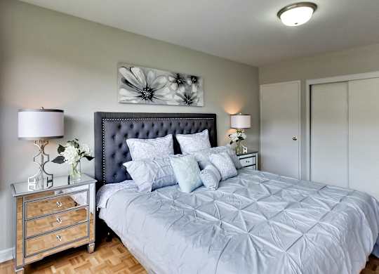 the master bedroom has a large bed and a large closet