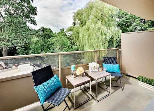 a patio with a table and chairs on a balcony