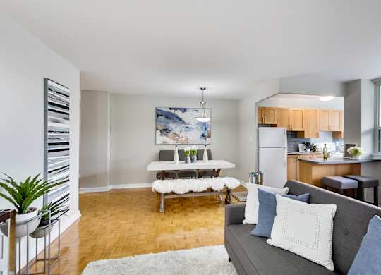 a living room with a couch and a table in a kitchen