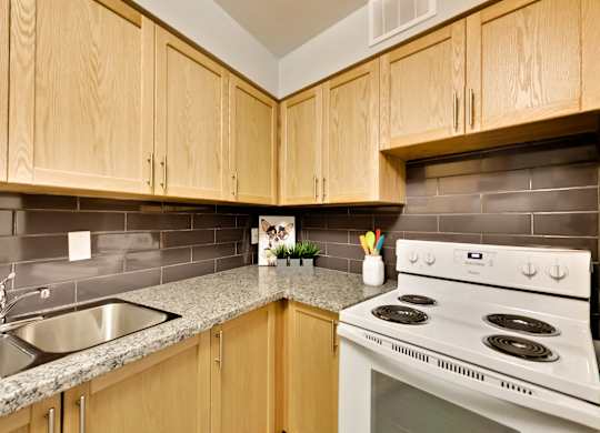 a kitchen with white appliances and granite counter tops