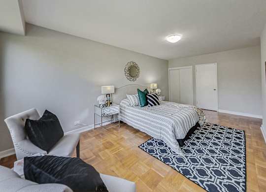 a bedroom with a bed and a couch and a chair