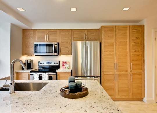 a kitchen with stainless steel appliances and a granite counter top