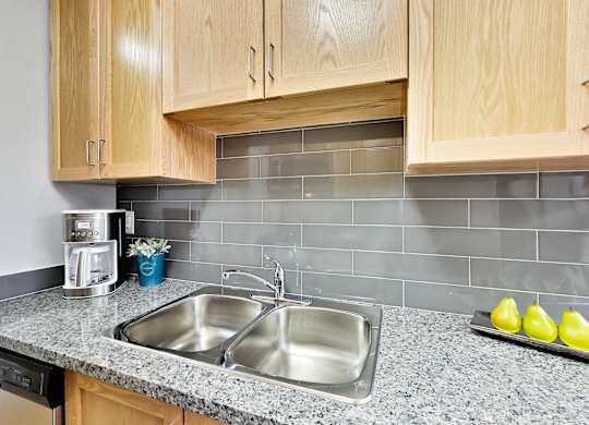 a kitchen with a sink and wooden cabinets