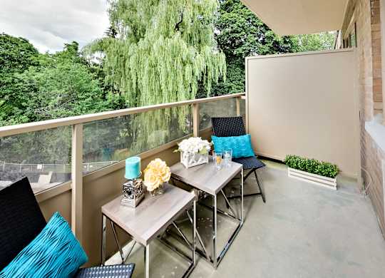 a patio with a table and chairs on a balcony