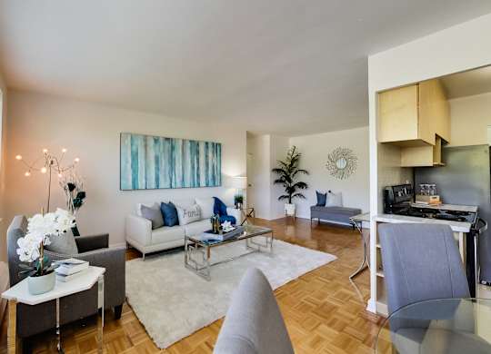 a living room with couches and chairs and a table