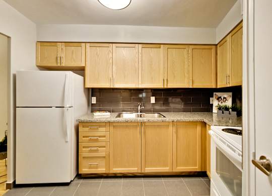 a kitchen with wooden cabinets and a white refrigerator